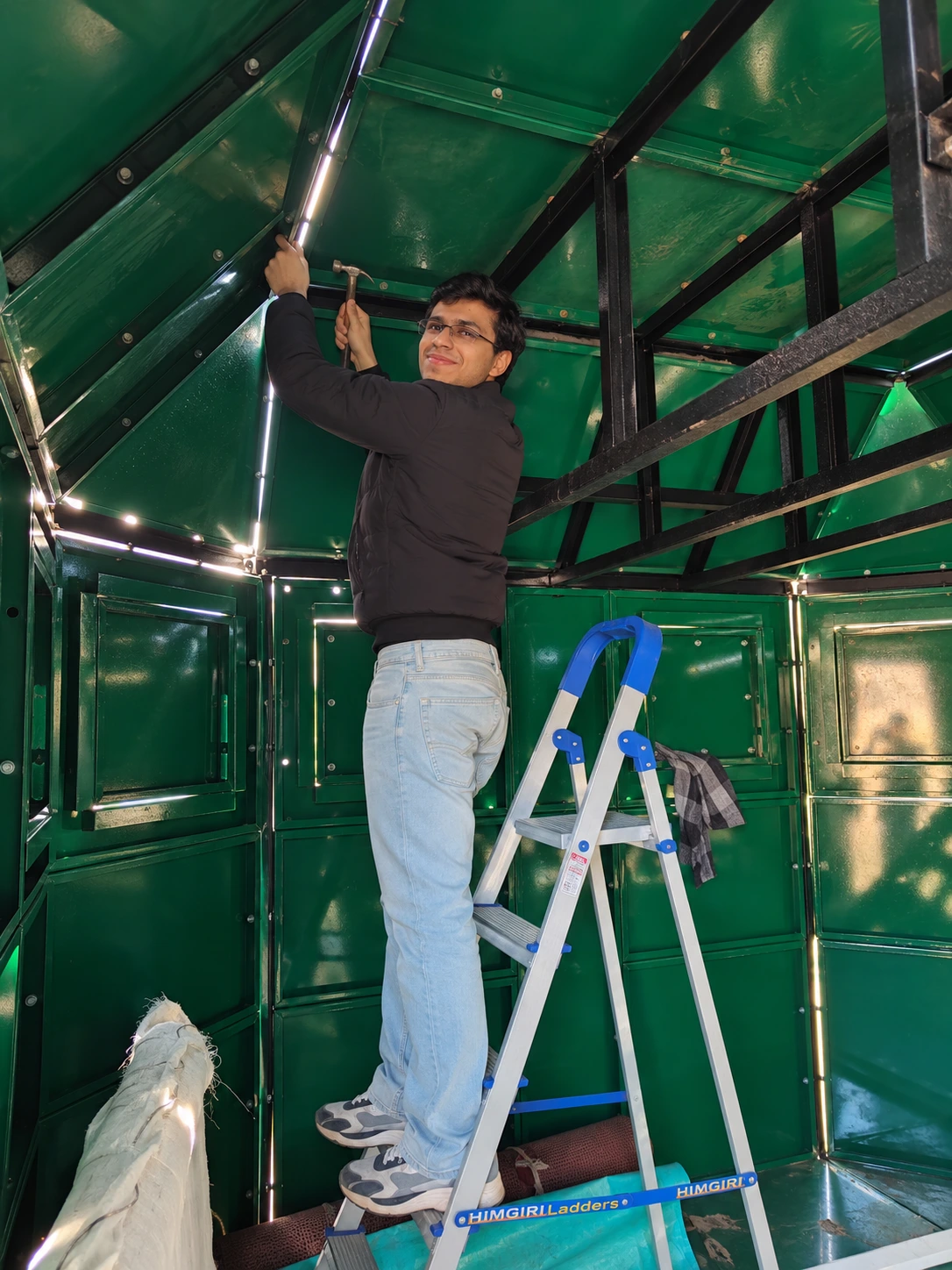 Ansh Bathija fitting the roof frame inside the bunker